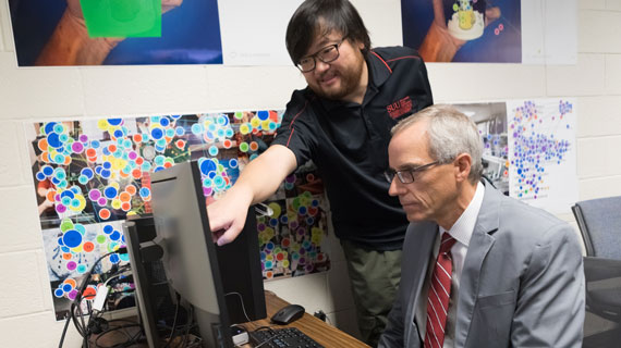 President Wyatt and Professor Lifie Zhou demonstrating the eye tracker software