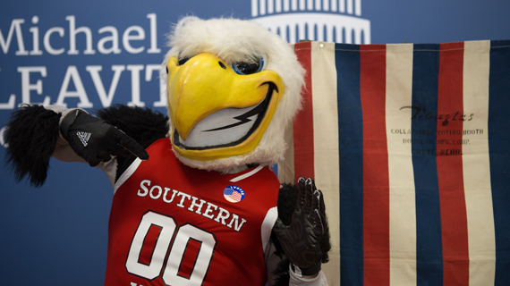 SUU's mascot Thor in a voting booth holding a sticker that says 'I Voted'