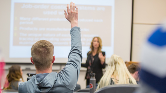 SUU Student raising their hand in an accounting class
