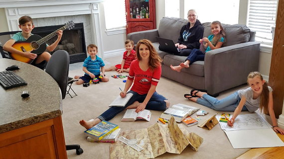 Shana Bartell, her five children and her little sister studying in their family living room.