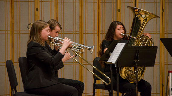 Students performing the trumpet and tuba in jazz band