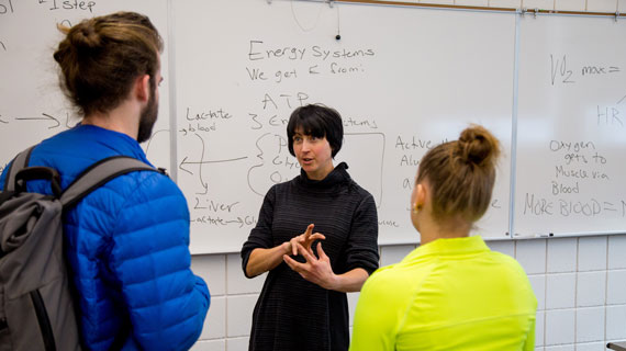 Professor Abigail Larsen with students in a classroom
