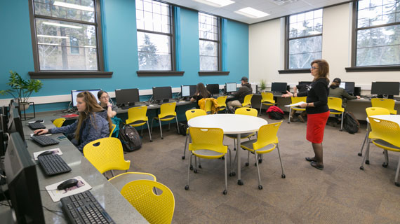 writing center director julia combs with students in the renovated space
