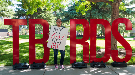 Student holding "My first last day" sign
