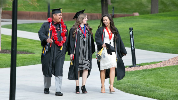 graduated students walking across campus