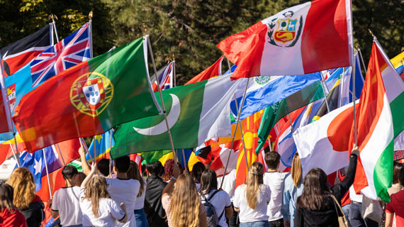 International students march in Homecoming Parade