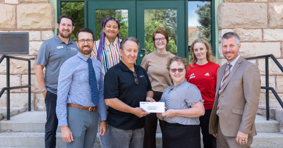 Group of STEM educators and administrators at Southern Utah University holding the check from Rocky Mountain Power Foundation for scholarships to benefit first generation students, SUU’s STEM Center, and the SUU First Tech Robotics program.