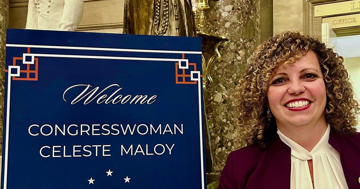 Congresswoman Celeste Maloy smiling by welcome sign