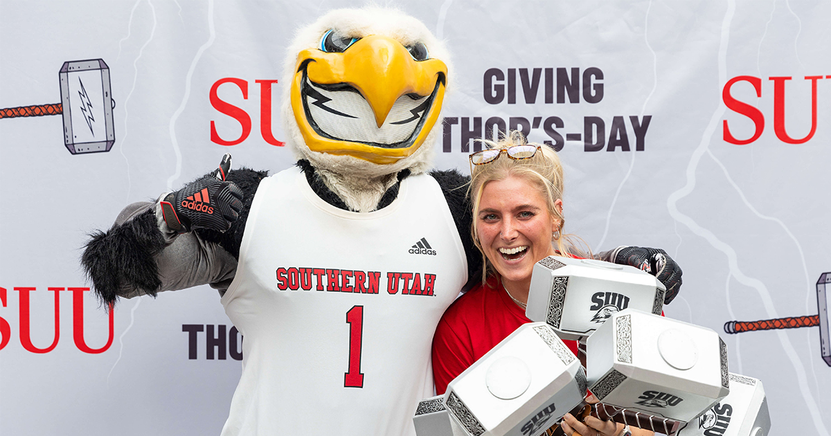 SUU's Mascot Thor the Thunderbird with a student holding multiple Hammers