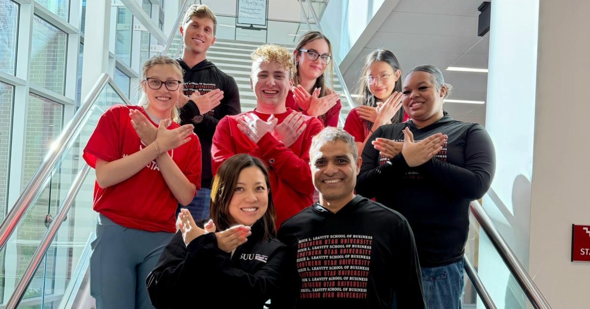 Analytics Team poses together with T-Bird hand symbol held up