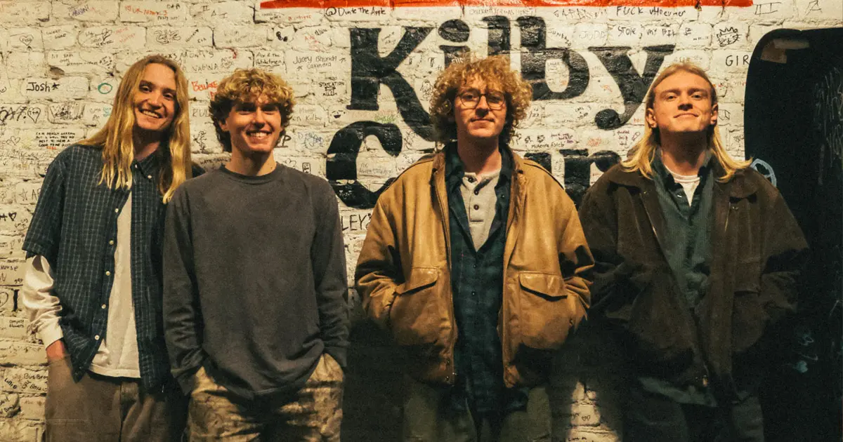 The band Black Cat Parade smiles at the camera.