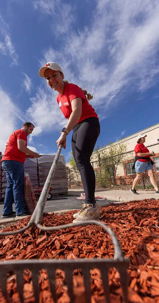 volunteer raking ground at SUU