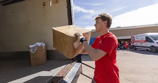 A volunteer loading boxes into a truck