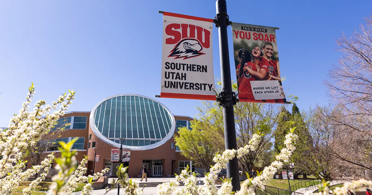 Gerald R. Sherratt Library and blossoms on a branch on SUU campus.