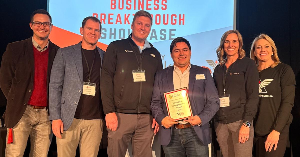 Eric Brinkerhoff holds his award