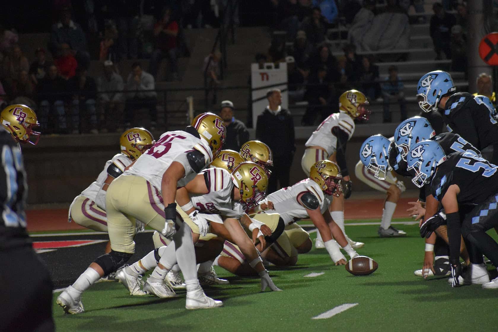Cedar High and Canyon View High football players in Coal Creek Rivalry game
