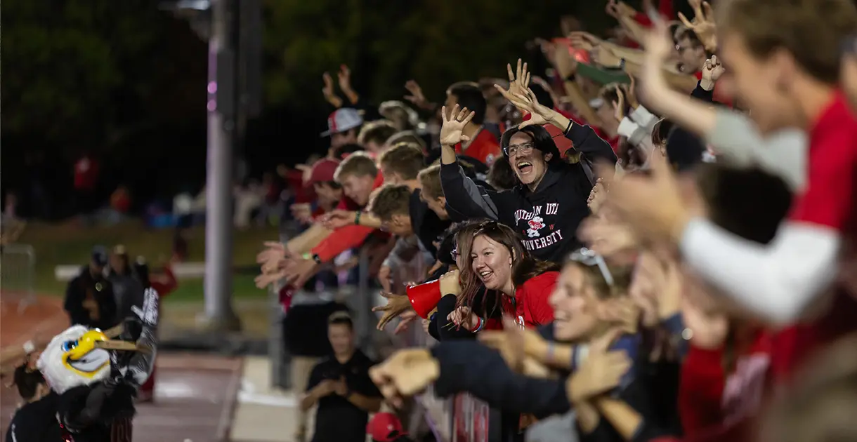 Students cheer at a football game