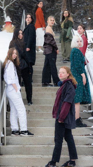 Nine Students Pose on a Staircase in the Winter.