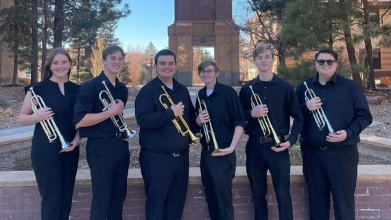SUU Trumpet Ensemble stands in front of Carter Carillon.