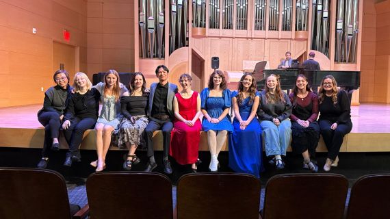 Students pose onstage after their NATS competition.