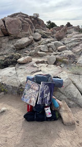 Photo of Herrmann's backpacking gear and paintings.