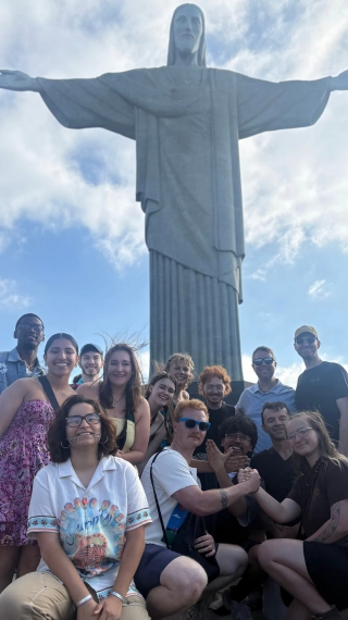 Percussion students pose in front of the "Cristo Redentor" statue in Rio de Janeiro.