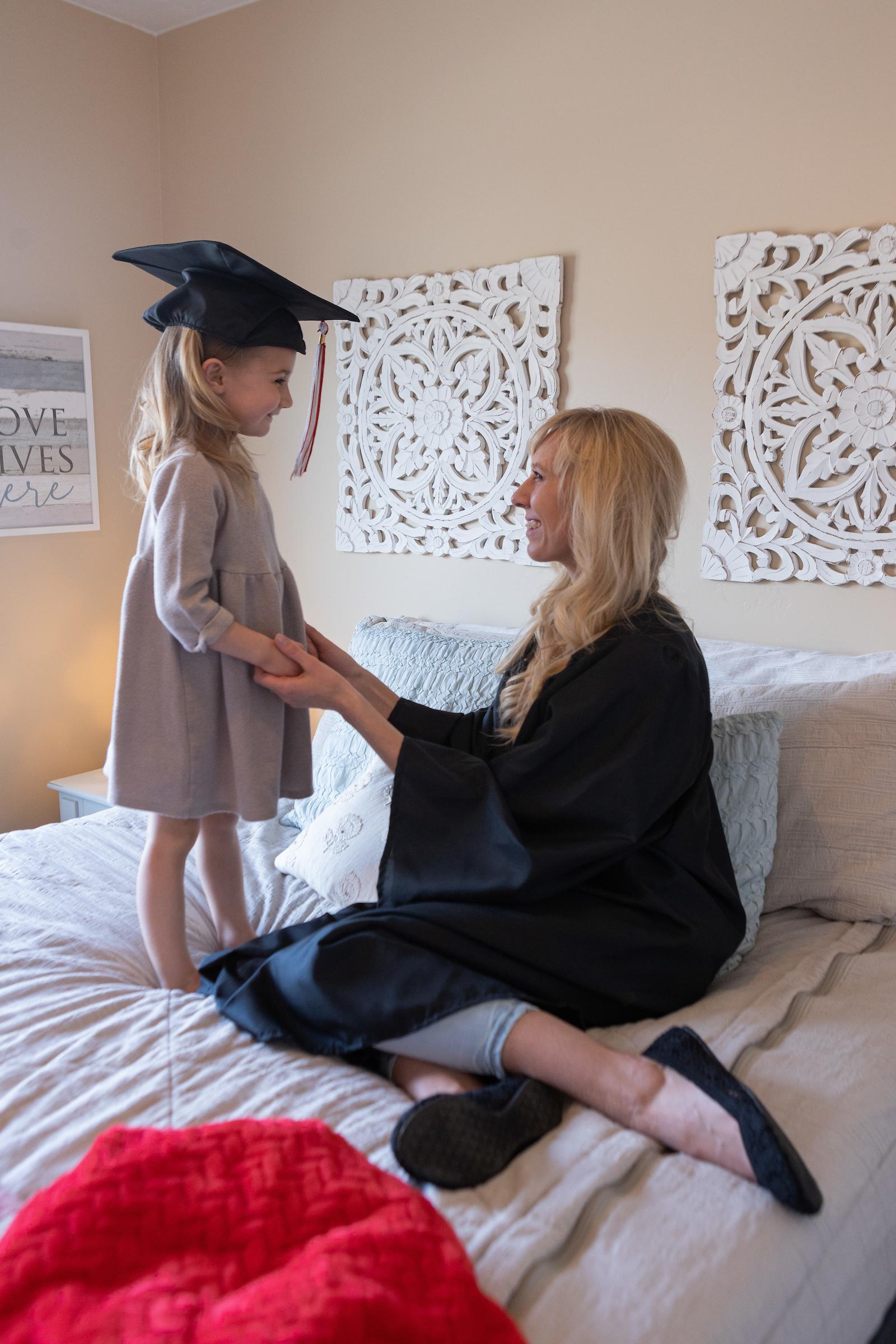 Bachelor of General Studies graduate in cap and gown with daughter