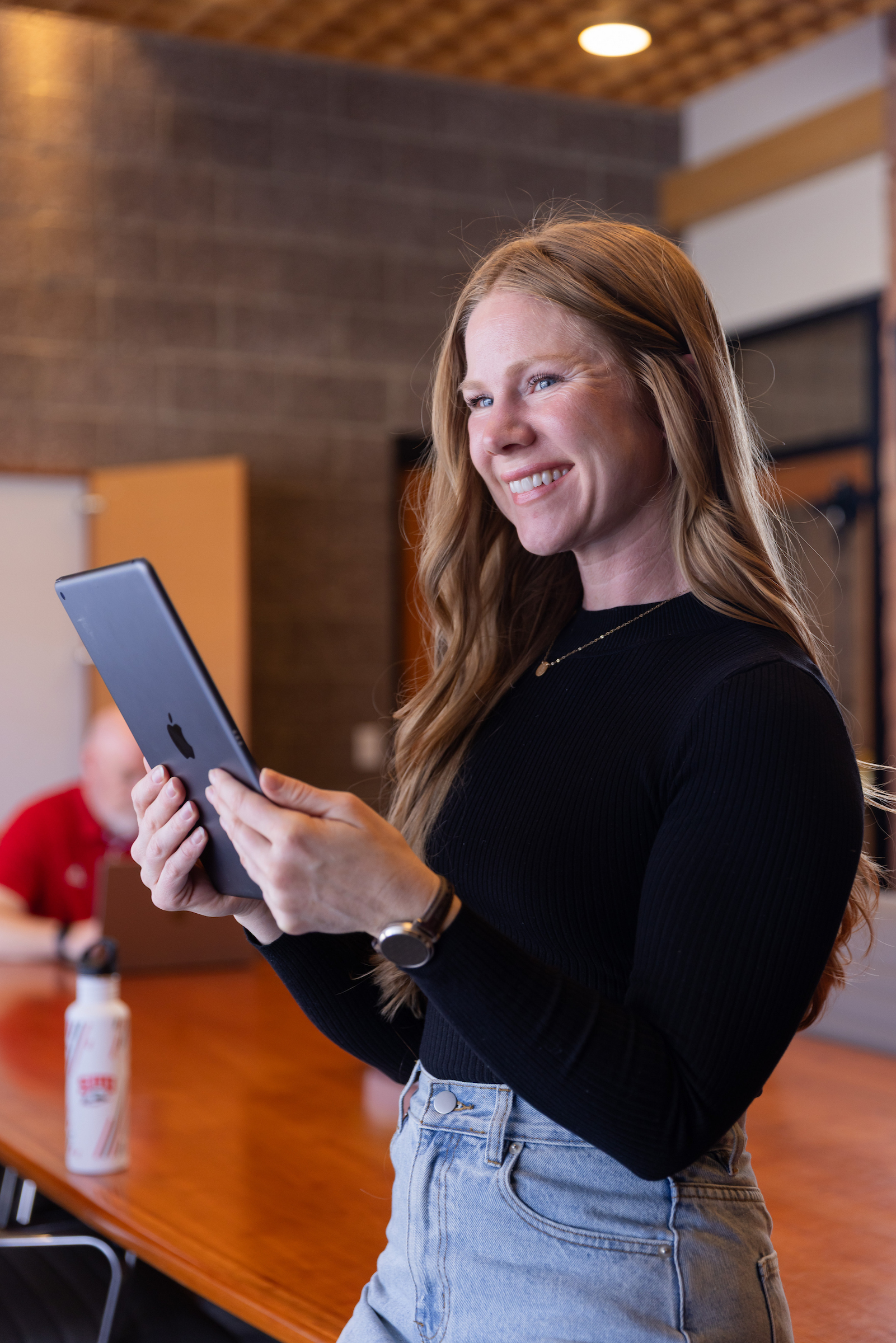 SUU online student female sitting and smiling at camera with laptop on lap