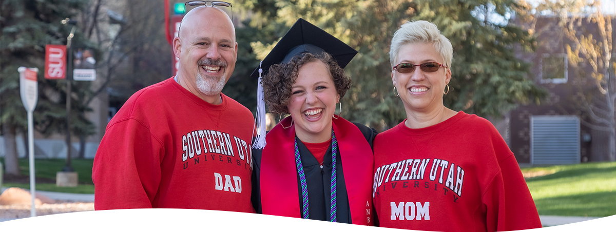 Portrait of graduating student with her parents