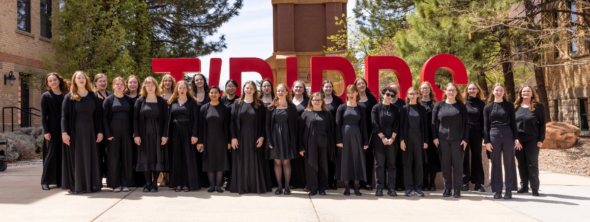 Photo of the Luminosa Treble Choir in front of the Carter Carillon. Spring 2026