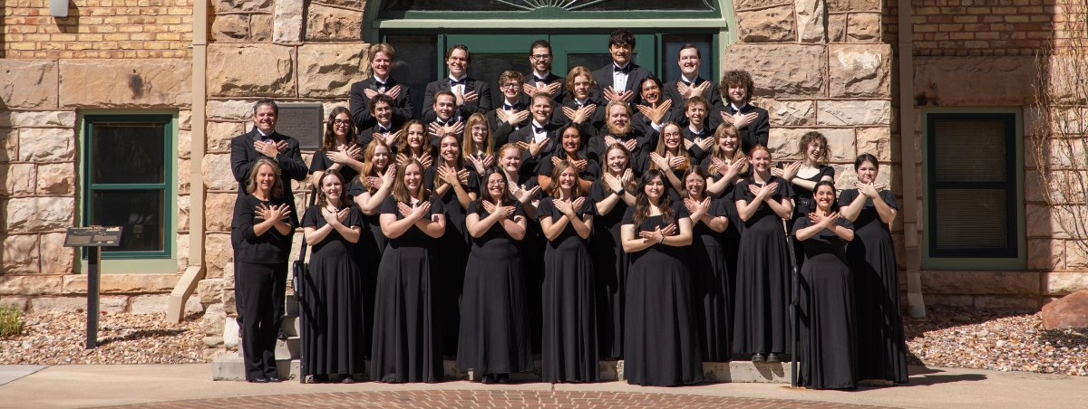 Photo of OPUS Chamber Choir outside of Old Main. Spring 2026.