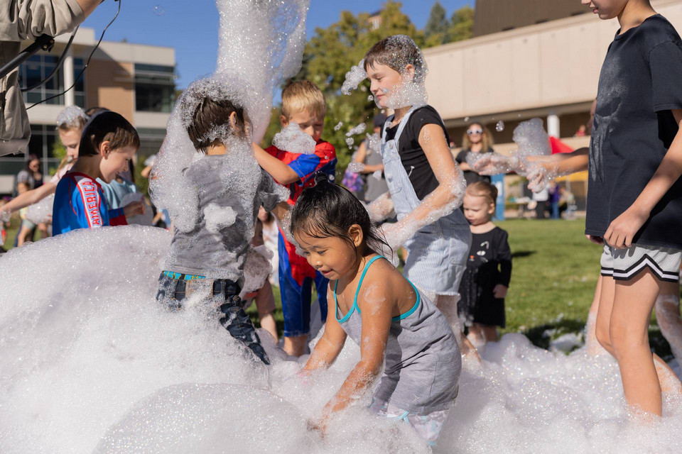 Children playing in foam