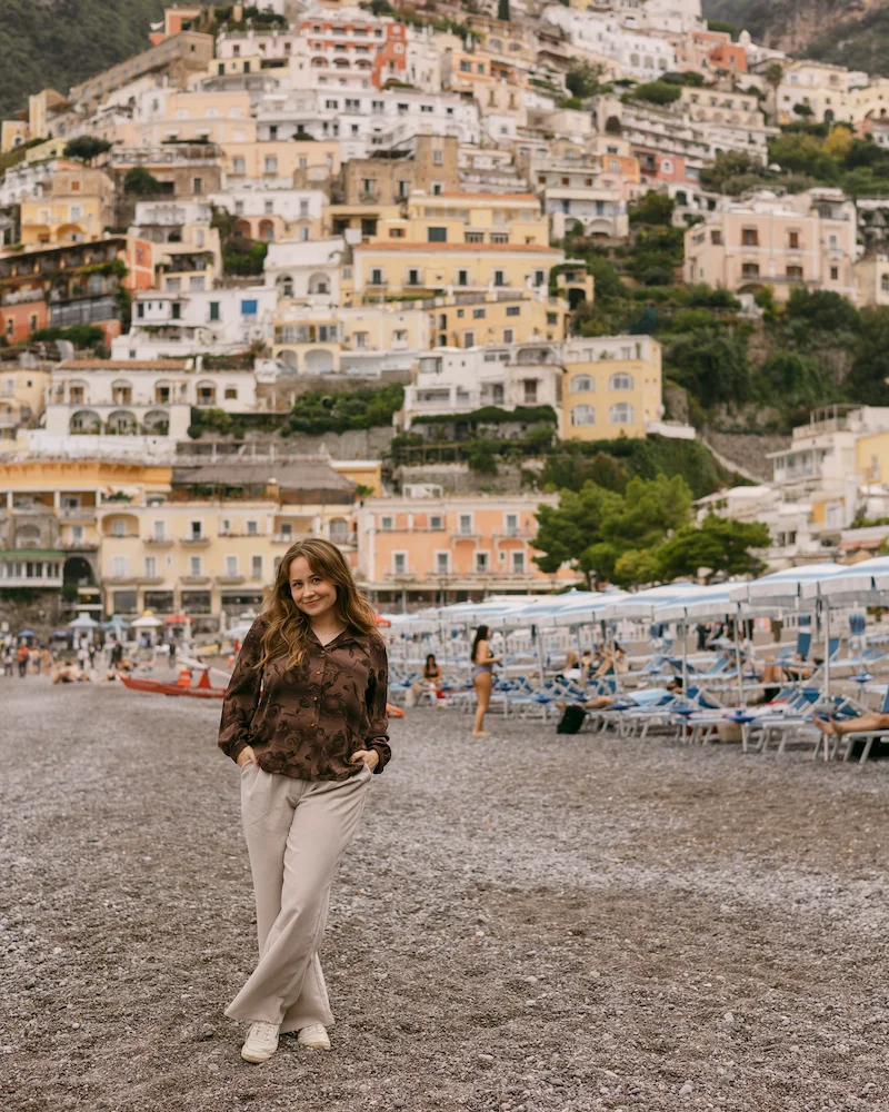 Student posing on beach abroad.