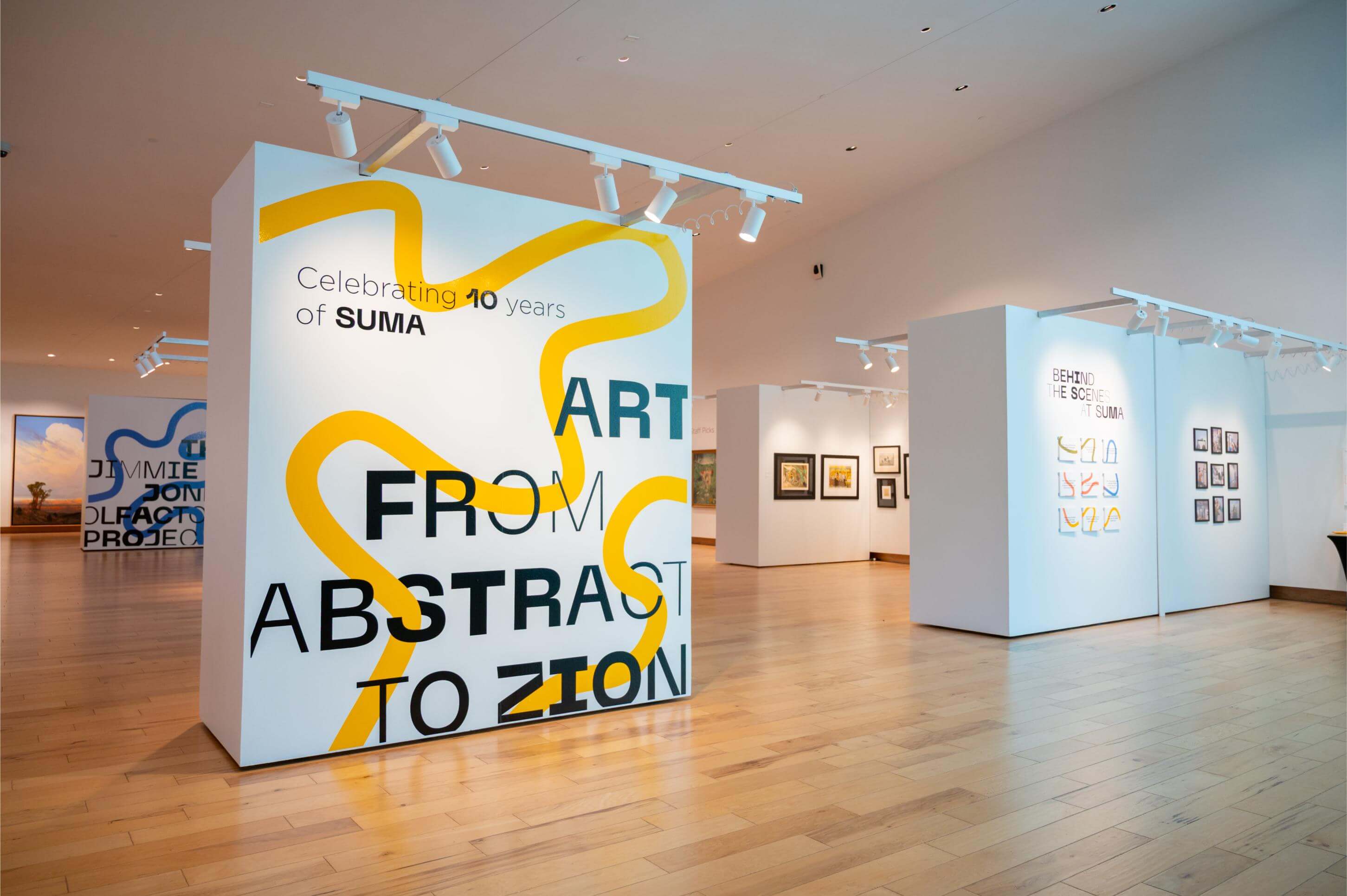 The main SUMA gallery with a title wall that says "Art from Abstract to Zion: Celebrating 10 Years of SUMA"