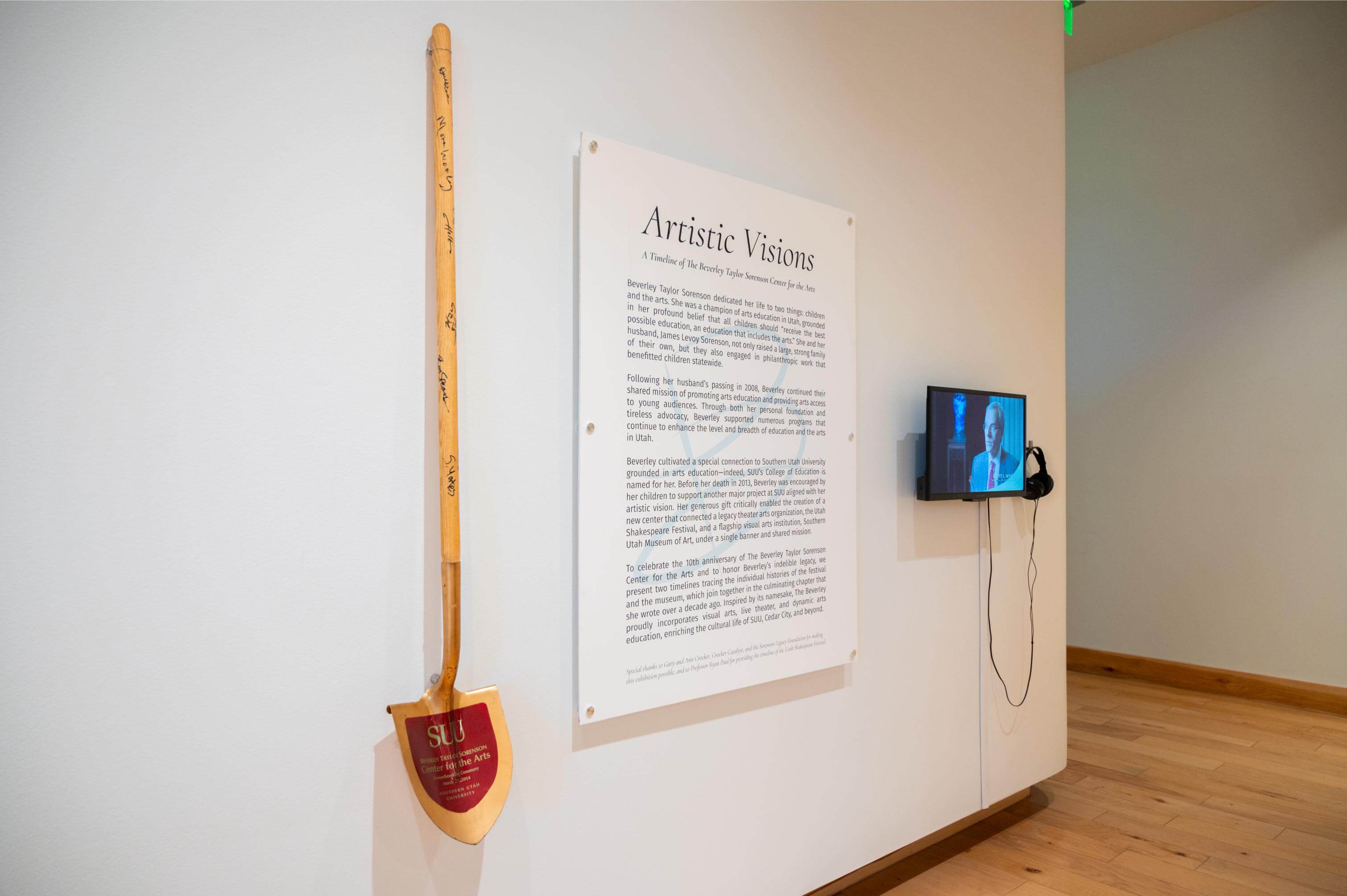 The exhibition entry graphic for Artistic Visions featuring a shovel from the groundbreaking, a text panel, and a video.