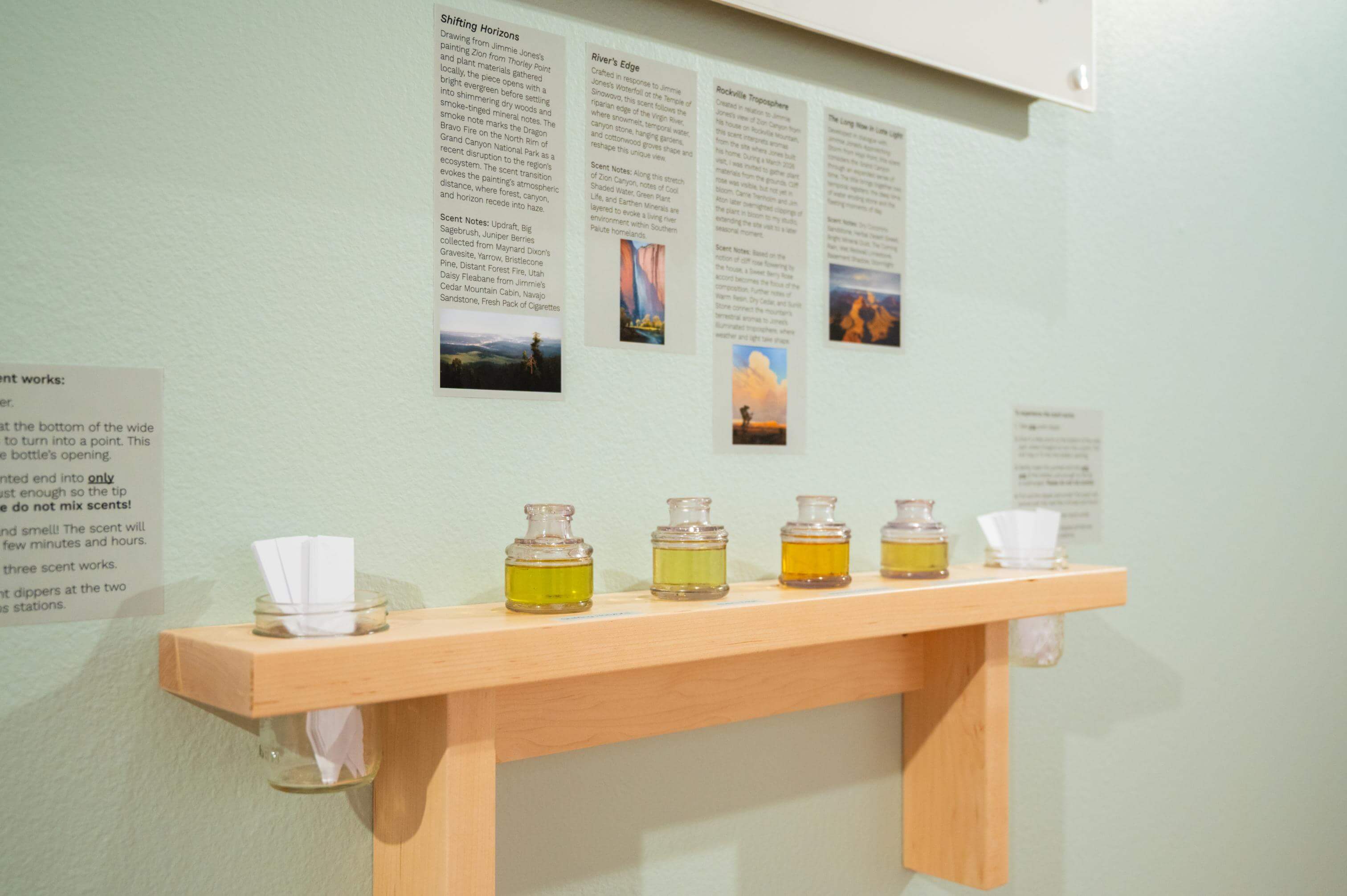 A display of four inkwells with custom scents connected to Jimmie Jones artworks