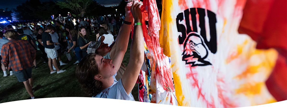 SUU Student tying up tie-dye shirt