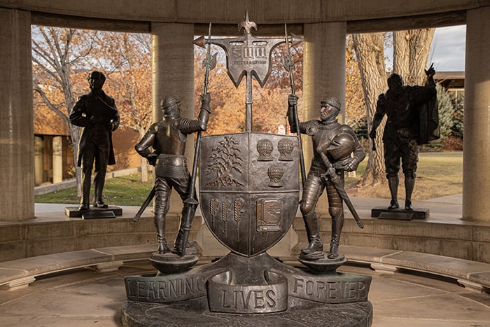 Knights surrounding the SUU coat of arms, above the words 'Learning Lives Forever'