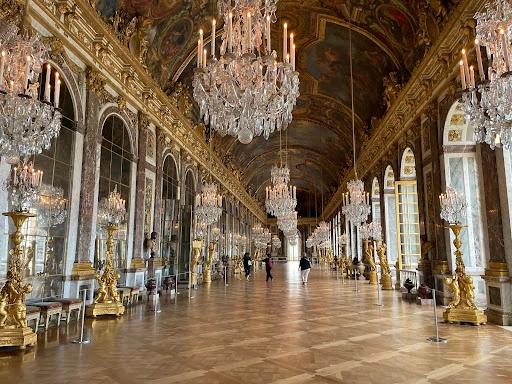 The Hall of Mirrors with chandeliers and mirrored walls.