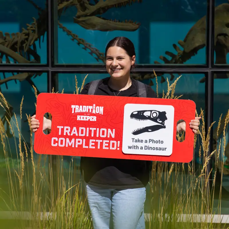 SUU Student holding a sign saying "1 tradition completed"