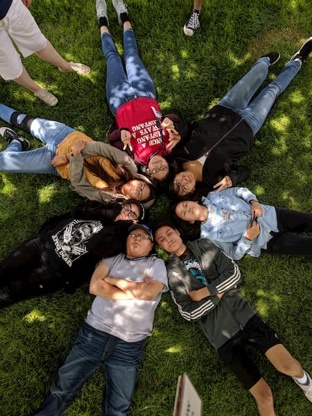 Students lying in the grass