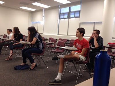 Students in classroom watching professor 