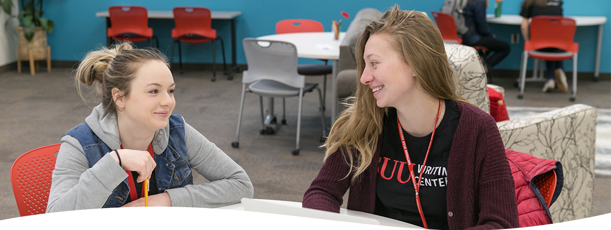 Two students working on a paper in the writing center