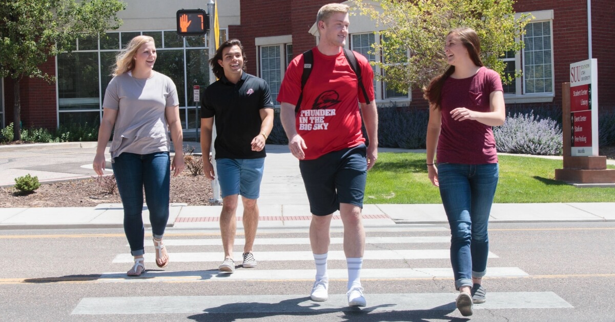 Students walking across a campus crosswalk